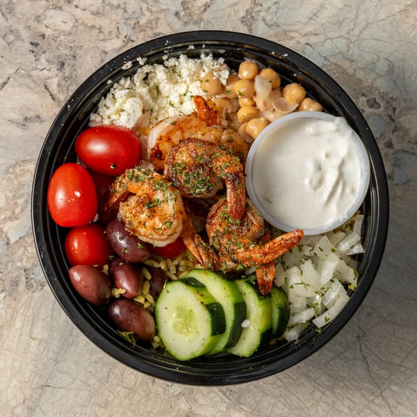 A Krazy Greek shrimp bowl with feta, chickpeas, tomatoes, olives, cucumbers, and tzatziki.
